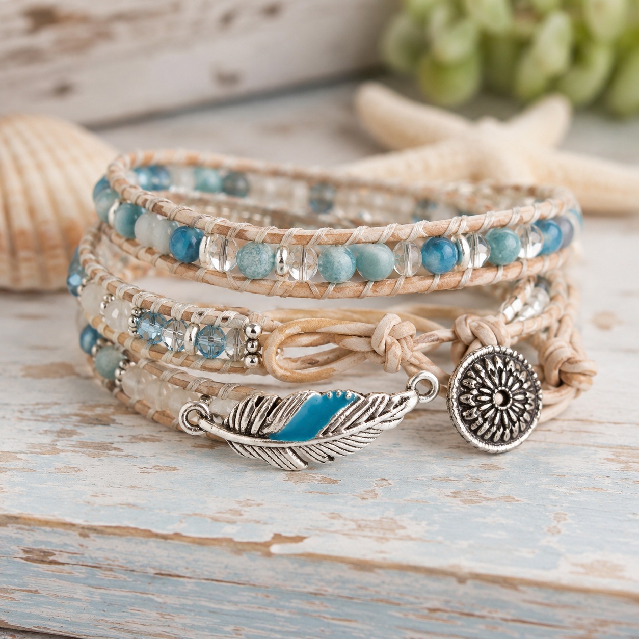 turquoise-feather-charm-boho-wrap-bracelet-finished-craft Handmade boho wrap bracelet featuring a turquoise feather charm with silver detailing, leather cord, and blue beads for DIY jewelry making and coastal-inspired crafts